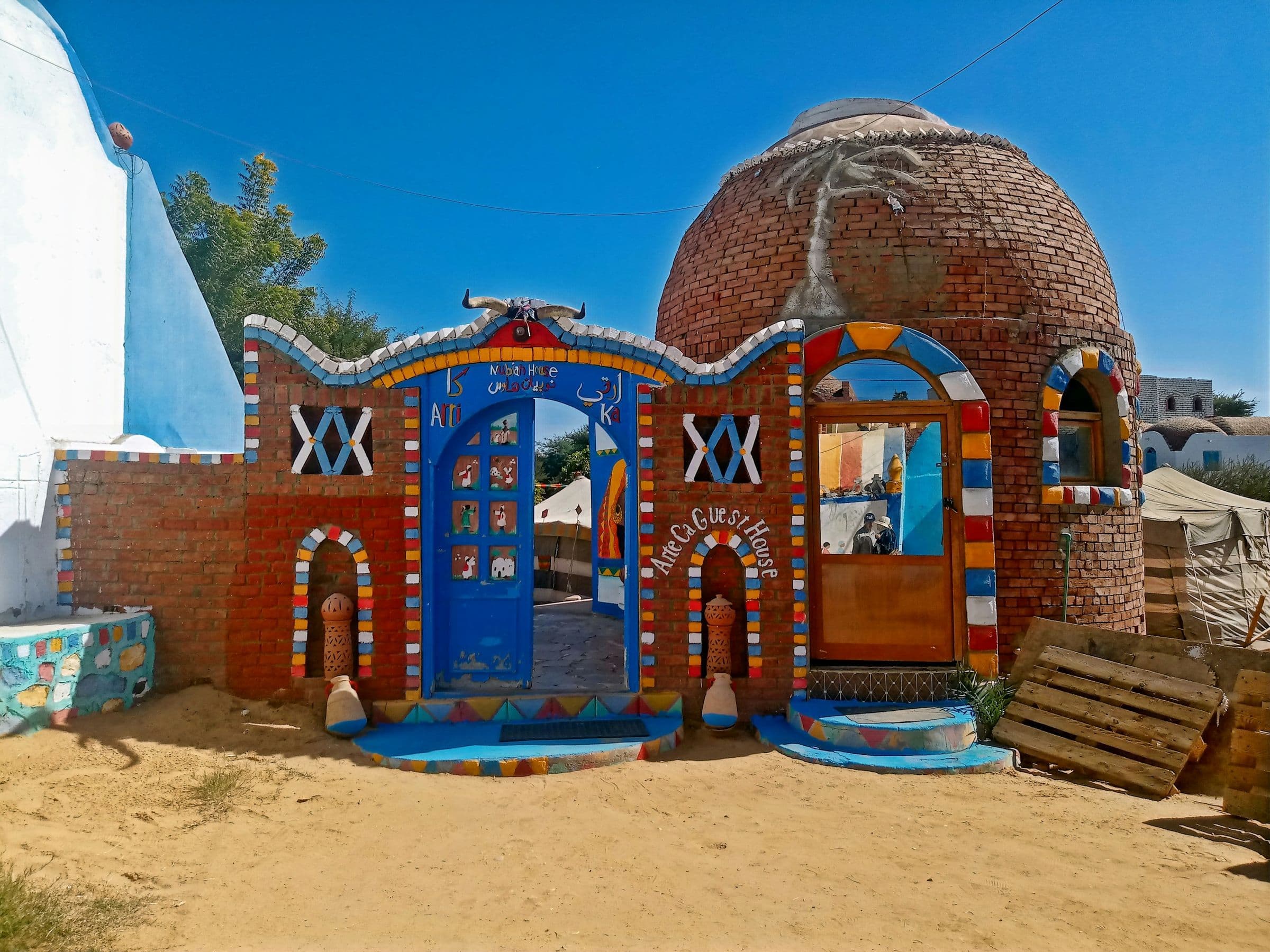 A brightly painted Nubian house with a domed roof